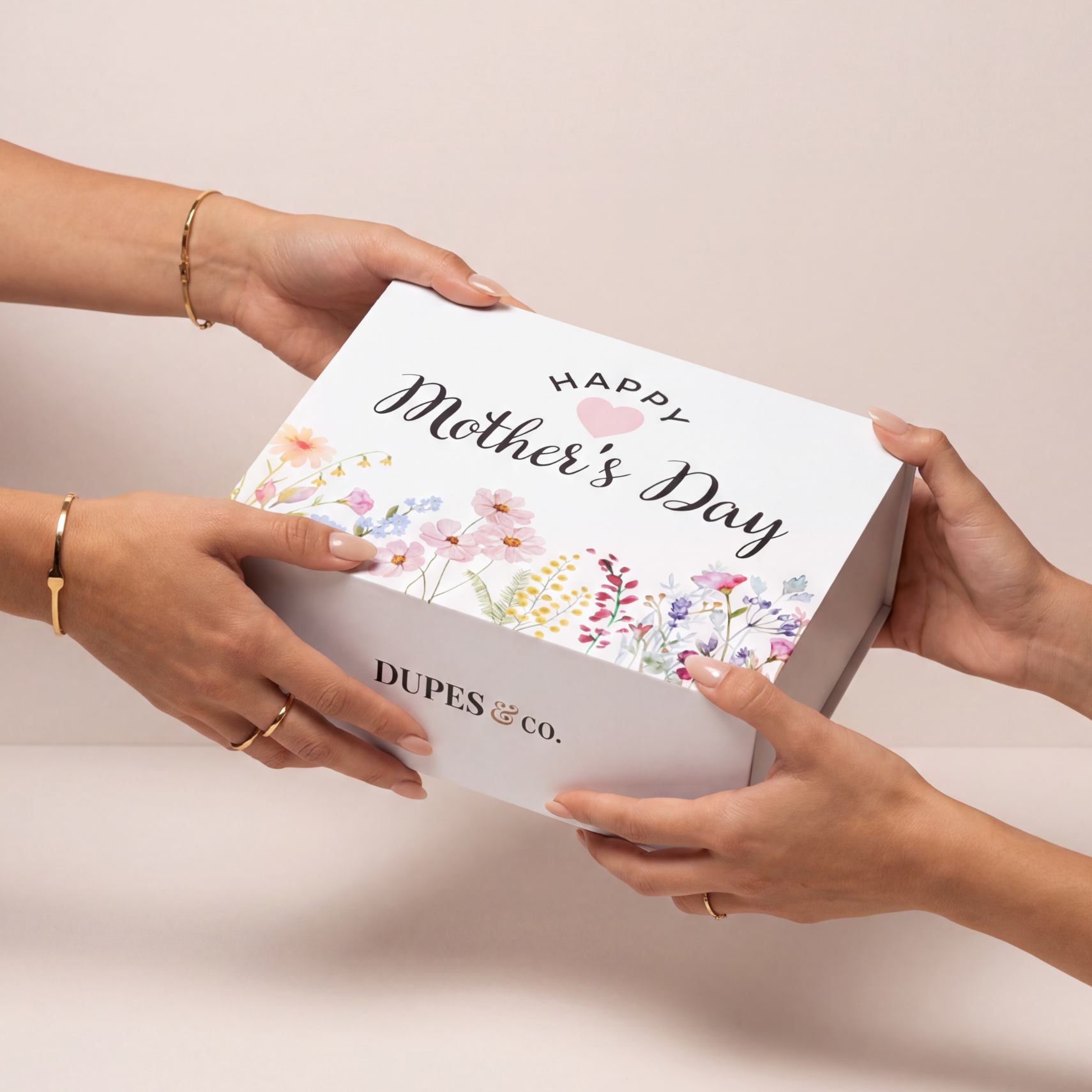 Hands passing the floral Happy Mother's Day keepsake gift box